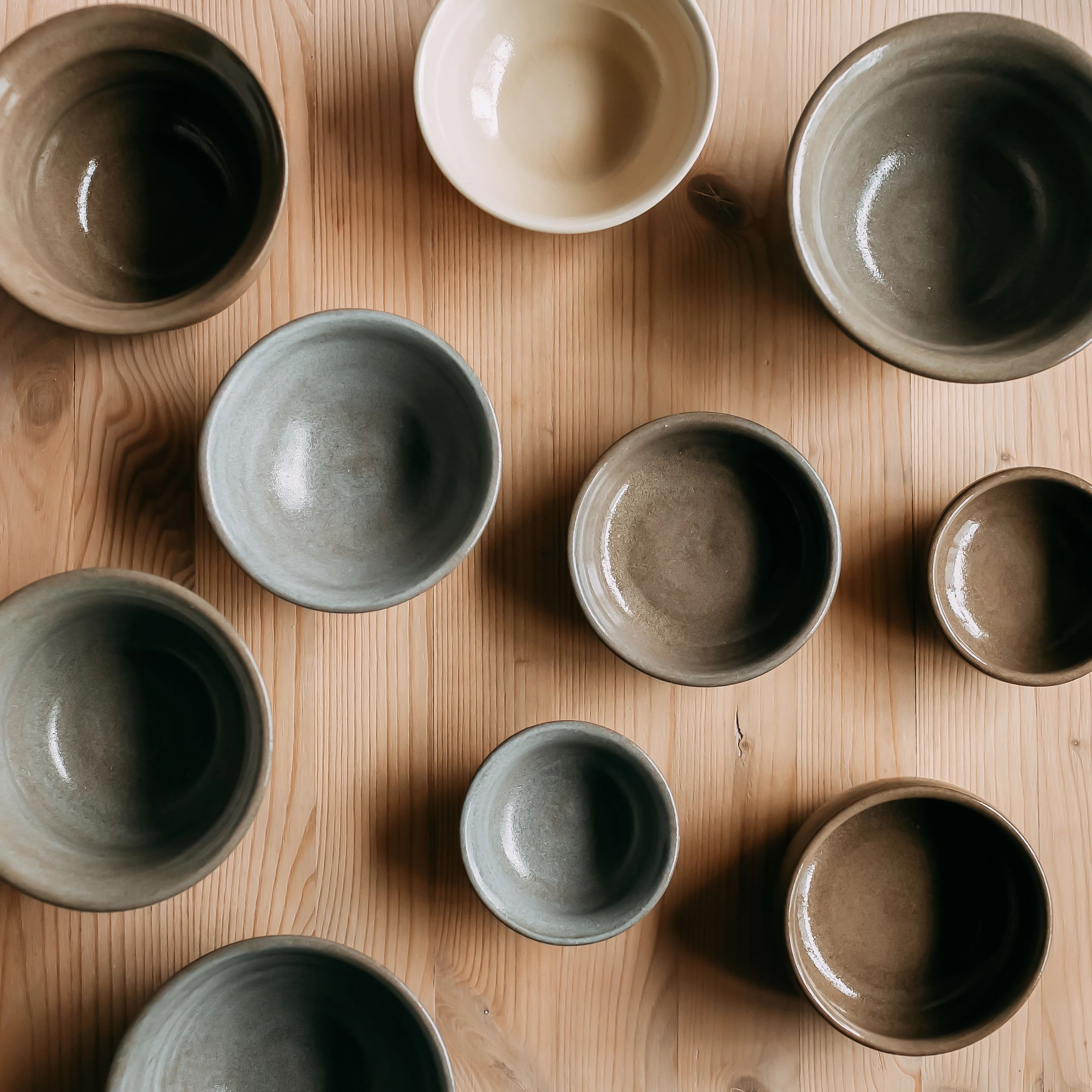 Ceramic bowls arranged on a wooden table